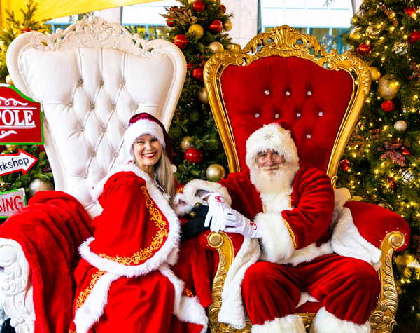 Santa and Mrs Claus for parties sitting in large chairs and smiling to camera for picture at holiday event | Altus Entertainment